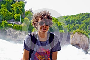 Portrait of happy boy in rhine falls in Switzerland