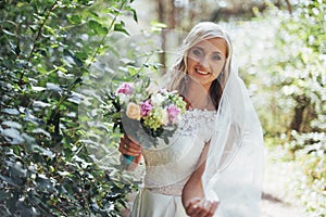 Portrait of a happy bride posing with veil