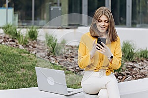 Portrait of happy business caucasian woman enjoy success on mobile phone. Closeup joyful girl reading good news on phone