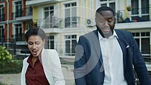 Portrait of happy business people celebrating victory outdoors. Couple dancing