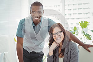 Portrait of happy business professionals at computer desk