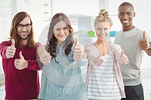 Portrait of happy business team with thumbs up