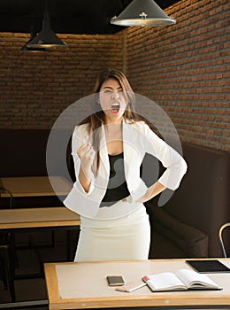 Portrait of happy business woman in coffee shop,Having enjoyed a really impressive success,victory dance, rewarded, won a good con photo