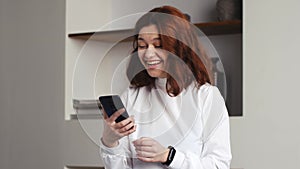 Portrait of happy business woman enjoy success on mobile phone at home office. Closeup joyful girl reading good news on