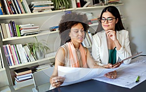 Portrait of happy business women working as a team at the office on meeting