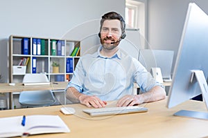 Portrait of a happy businessman, man working remotely, using a headset for a video call