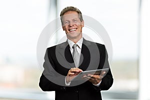Portrait of happy businessman with pc tablet.