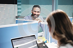 Portrait Of Happy Businessman Smiling At Camera In Coworking Office