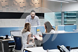 Portrait Of Happy Businessman Smiling In Coworking With Colleagues