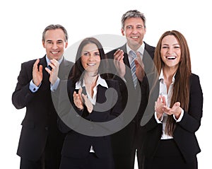 Portrait of happy businesspeople clapping