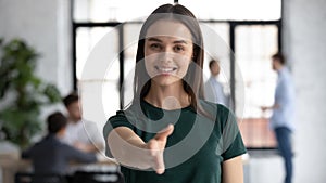 Portrait of happy businesswoman stretch hand welcoming newcomer