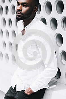 Portrait of a happy casual afro American man standing with hands