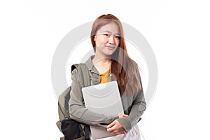Portrait of happy casual Asian girl student with backpack and laptop isolated on white background. Back to school and learning