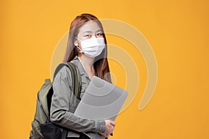 Portrait of happy casual Asian girl student wearing face mask to study with backpack and laptop back to school and learning