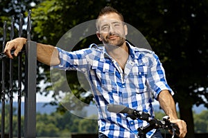 Portrait of happy casual man on bicycle outdoor