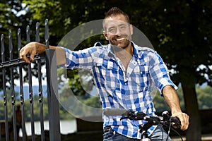 Portrait of happy casual man on bicycle outdoor