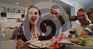 Portrait of happy caucasian multi-generation family at table during family meal