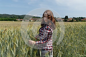 Portrait of a happy caucasian woman in the field of wheat