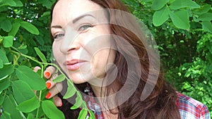 Portrait of a happy caucasian woman in the forest close up