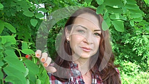 Portrait of a happy caucasian woman in the forest close up