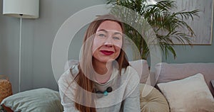Portrait of happy cheerful 30-35 smiling blonde Caucasian woman talking and waving looking at camera. Video call concept