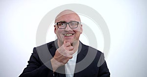 A portrait of a happy, cheerful, joyful middle-aged bald businessman in glasses and a black jacket, he is in the Studio