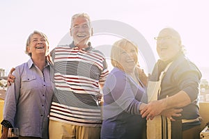 Portrait of happy and cheerful mature senior people enjoying friendship outdoor. Retired group of friends standing and posing for