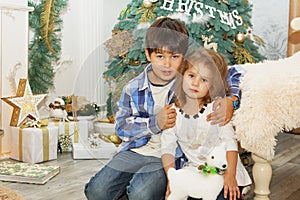 Portrait of a happy children - boy and girl. Little kids in Christmas decorations. Brother and sister