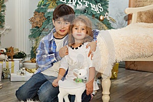 Portrait of a happy children - boy and girl. Little kids in Christmas decorations. Brother and sister