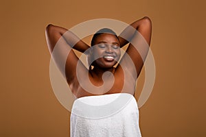 Portrait of beautiful plus size African american woman showing armpits