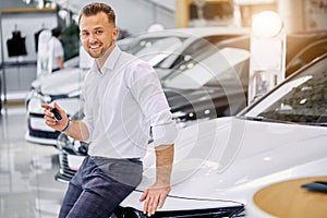 Portrait of happy client man buying new car