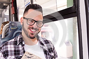 Portrait of happy commuter student man taking public transport i