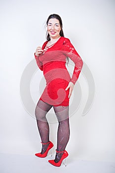 Portrait of happy and confident plus size model in red dress