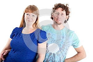 Portrait of happy couple embracing and looking at camera, isolated white background