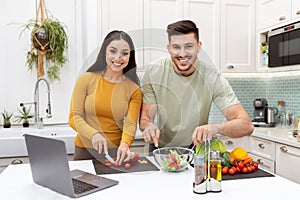 Portrait of happy couple enjoying time together, cooking dinner