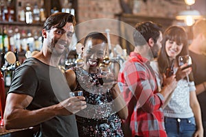 Portrait of happy couple holding drinks