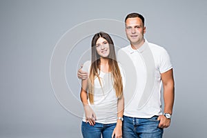 Portrait of happy couple looking at camera on gray background