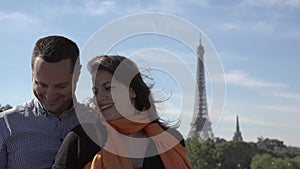 Portrait of happy couple making selfie, Eiffel tower in background, man and woman smiling, sweet tenderness,