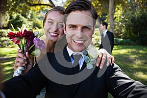 Portrait of happy couple posing in park