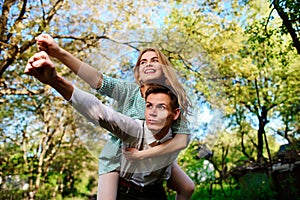 Portrait of happy couple raising their hands in open air