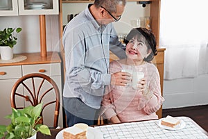 Portrait of happy couple senior asia woman and retirement man having breakfast together