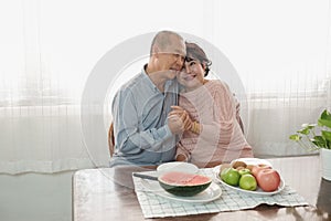 Portrait of happy couple senior asia woman and retirement man having breakfast together