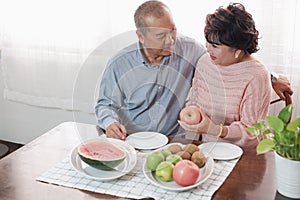 Portrait of happy couple senior asia woman and retirement man having breakfast together