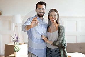 Portrait of happy couple show house keys