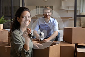 Portrait of happy couple show keys to new home