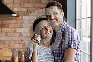 Portrait of happy couple show keys to new home