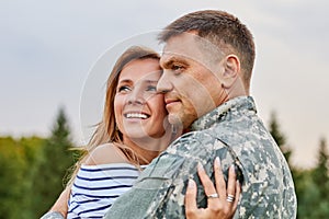 Portrait of happy couple with soldier.