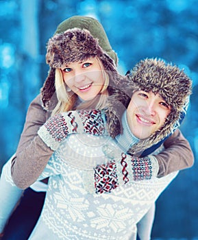 Portrait happy cozy young couple having fun outdoors in winter