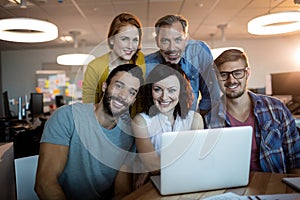 Portrait of happy creative business team working on the laptop