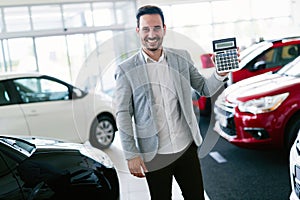 Portrait of happy customer buying new car